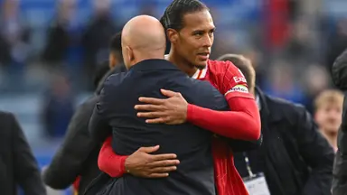 Liverpool Man City compensation: Virgil van Dijk embracing manager Arne Slot during a match