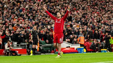 Szoboszlai fitness update: Dominik Szoboszlai in a Liverpool kit celebrating on the pitch at Anfield